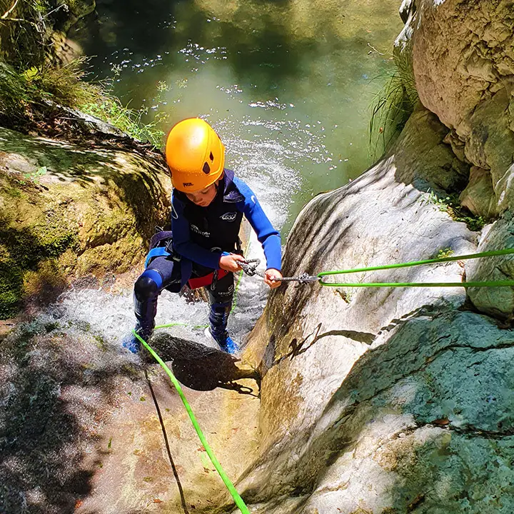 Abseiling down waterfall in canyoning Ganière, Gorges du Loup, french riviera - Les Geckos