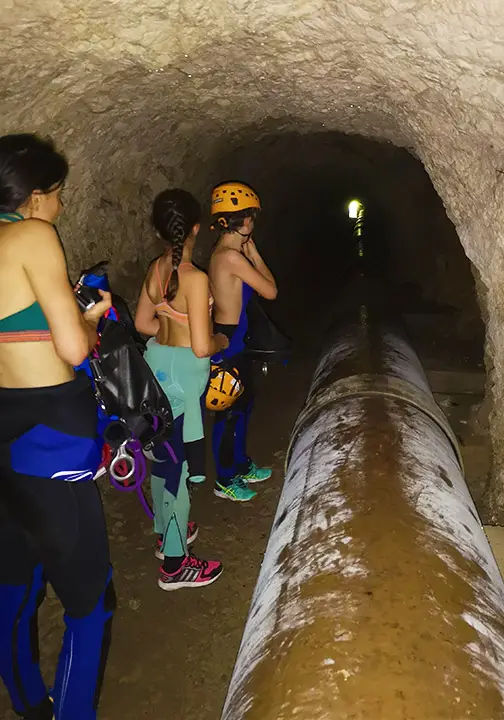 Walking through tunnels on the way to canyoning in the Gorges du Loup - Les Geckos