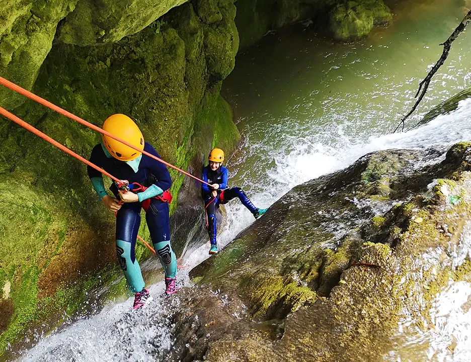 Abseiling down waterfall in canyoning Ganière, Gorges du Loup, french riviera - Les Geckos