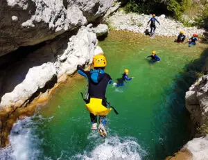Jumping in clear water while canyoning Gours du Ray, Gréolières, Gorges du Loup, french riviera - Les Geckos